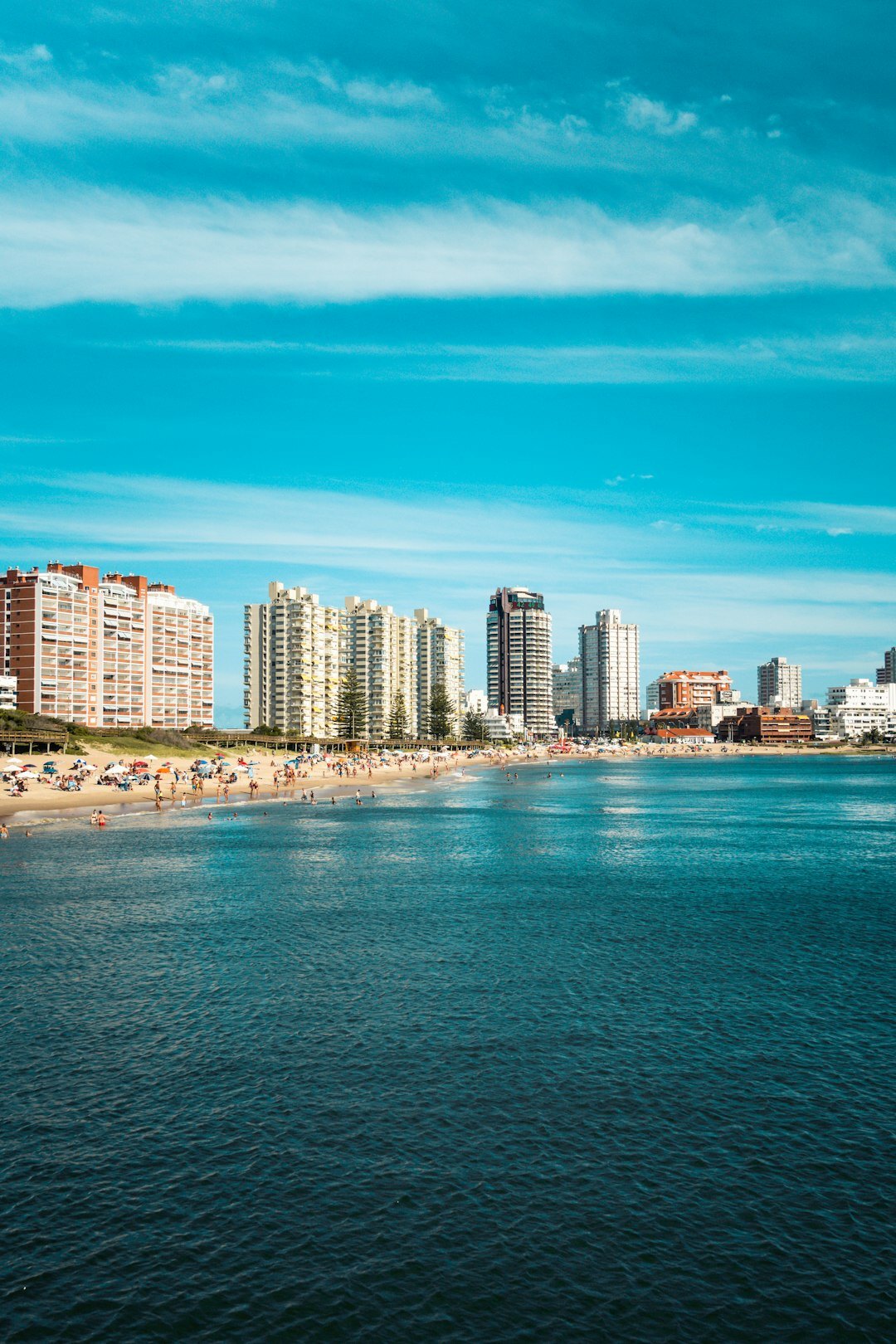 Skyline of Punta del Este with beach and high-rise buildings at dusk