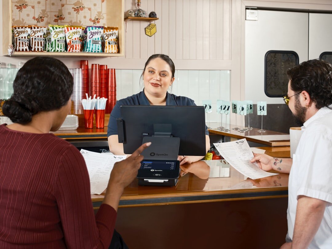 Advisor and clients reviewing property documents at a minimalist office table